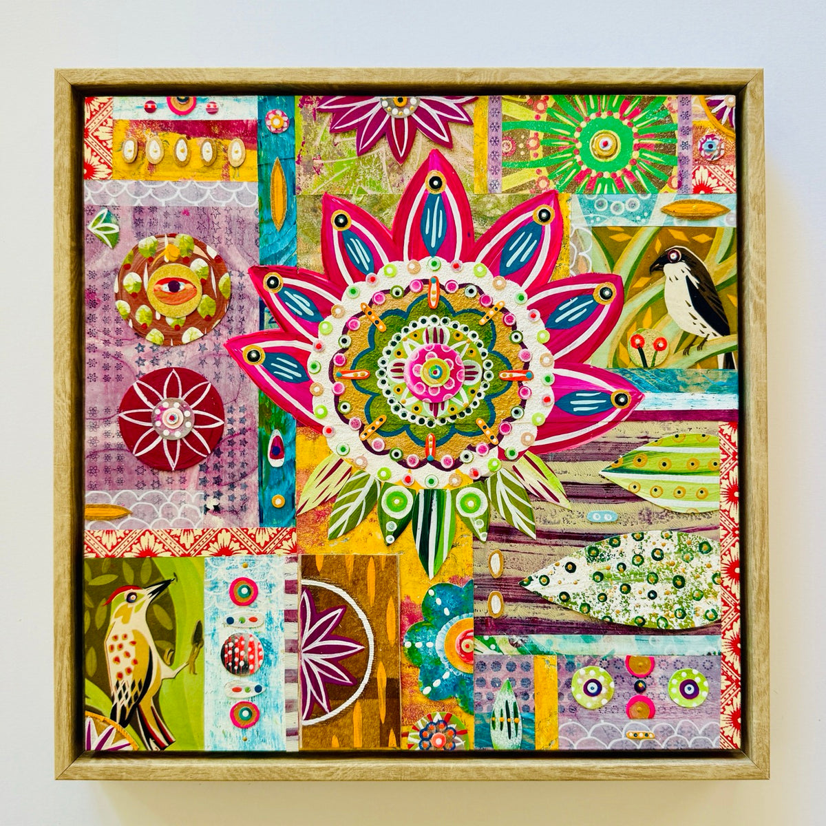 Colorful abstract artwork with floral patterns and birds in a wooden frame.