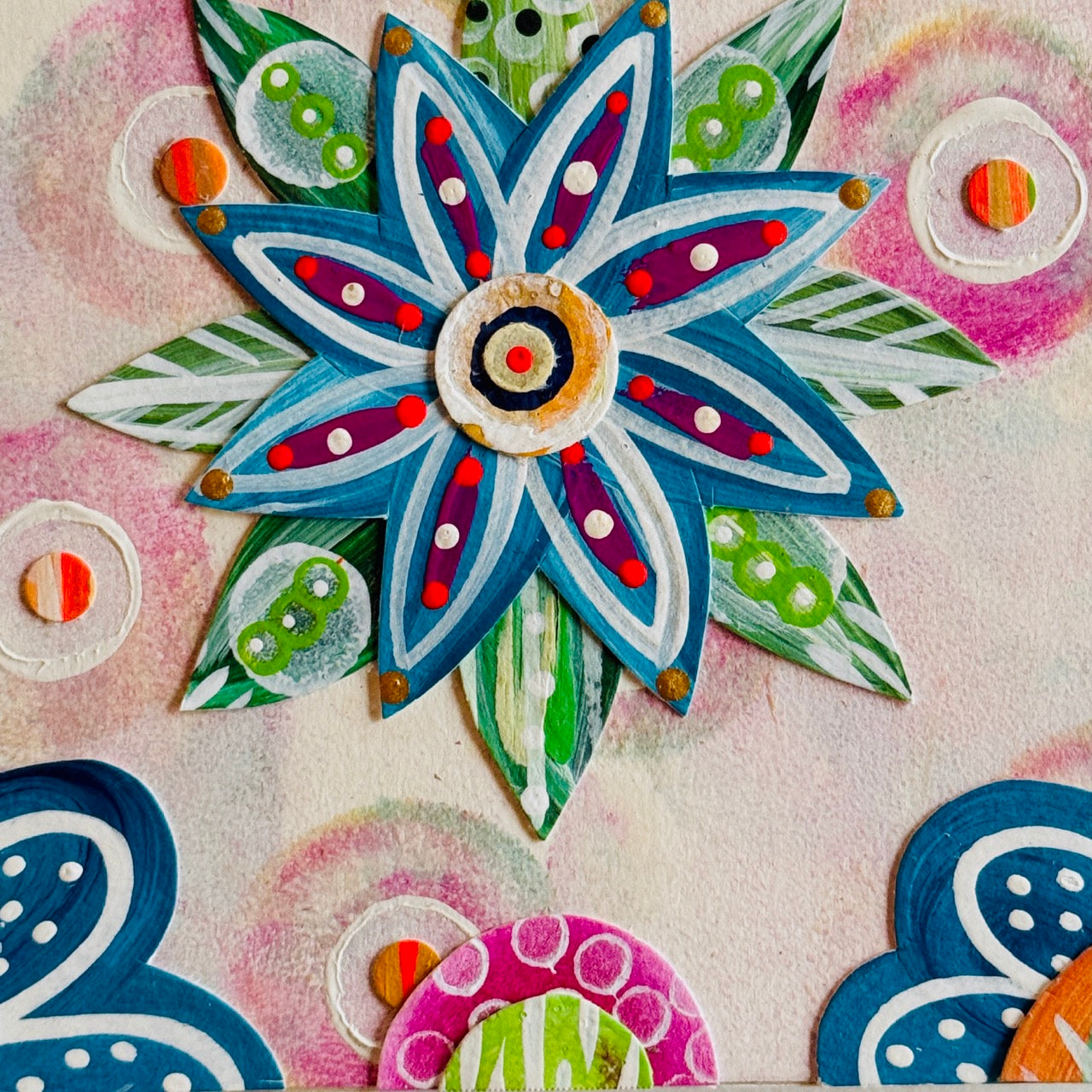 Small square wood panel art with a bold patterned floral design and hand-painted collage elements.