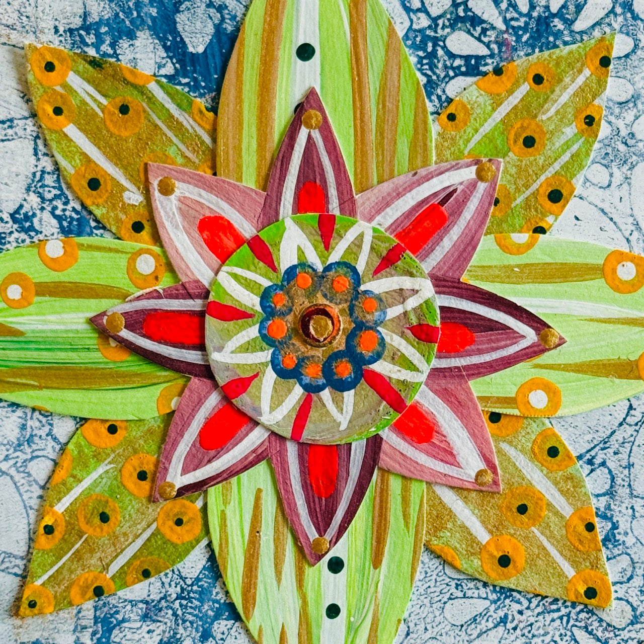 Small square wood panel art with a bold patterned floral design and hand-painted collage elements.