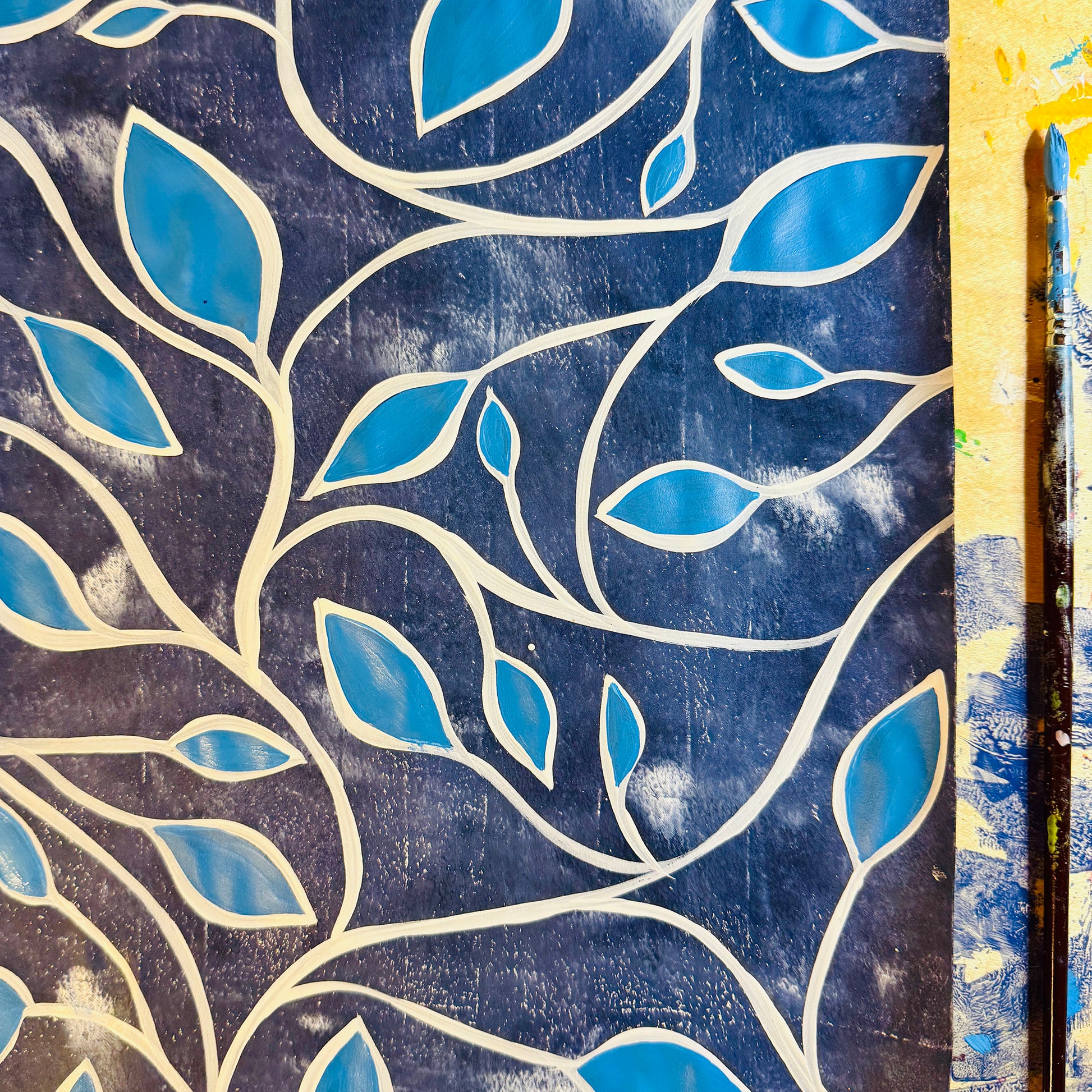 Artistic depiction of blue leaves on a textured blue background