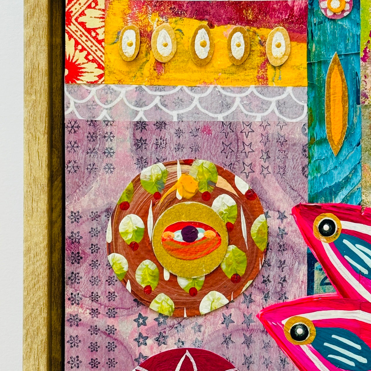 Colorful abstract art piece with eye-like shapes and patterns on a textured background