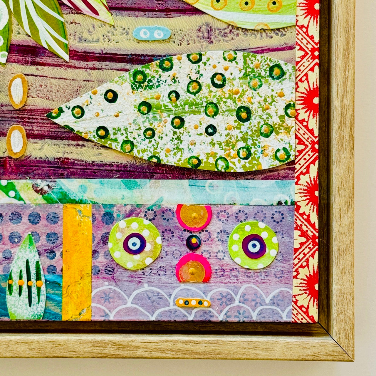 Colorful abstract art piece with patterns and shapes in a wooden frame.