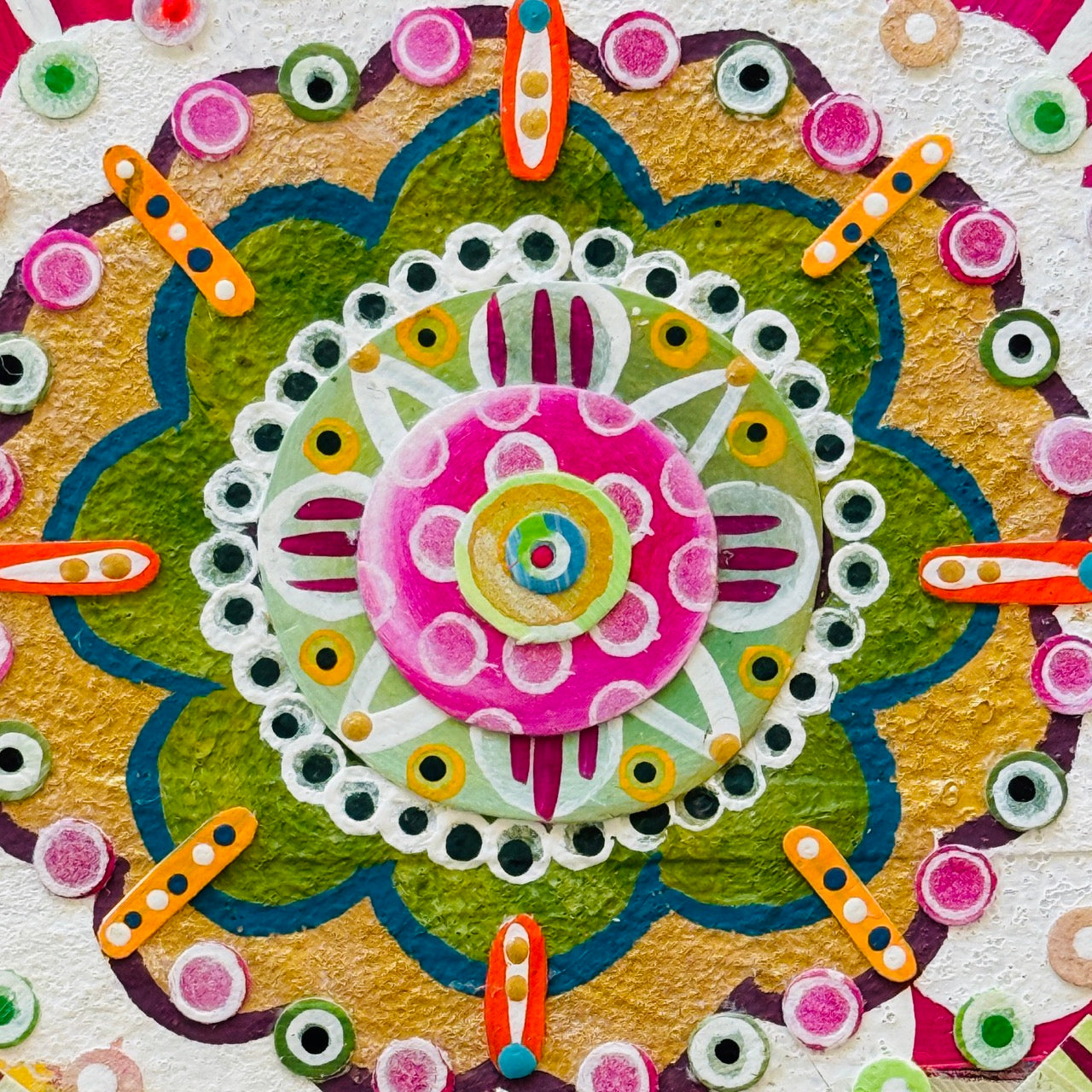 Colorful mandala design with various shapes and patterns on a textured background