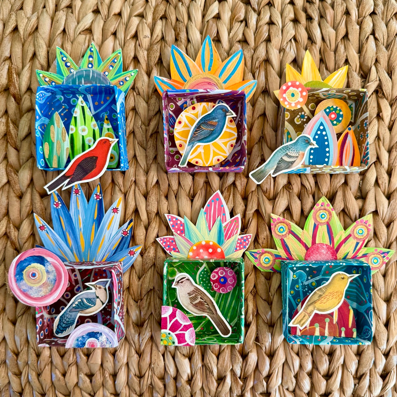 Colorful bird-themed paper boxes with birds and cut paper collage 
