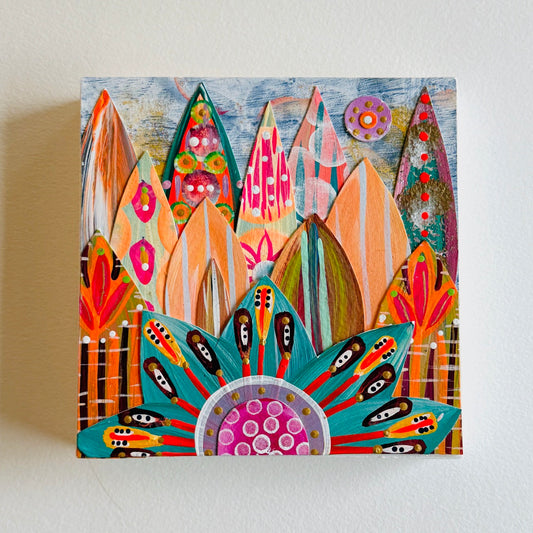 Small square wood panel art with a bold patterned floral design and hand-painted collage elements.