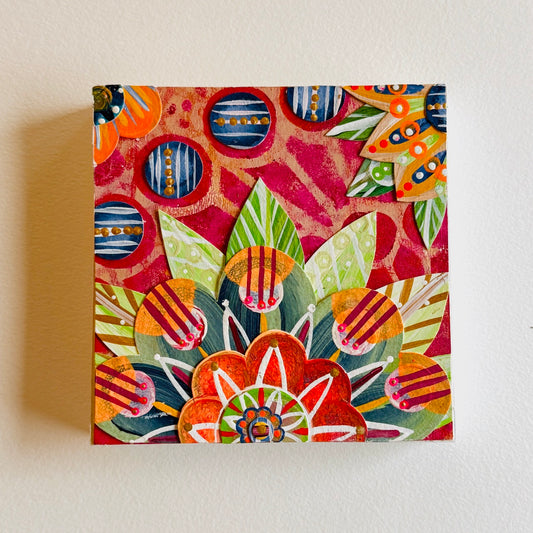 Small square wood panel art with a bold patterned floral design and hand-painted collage elements.