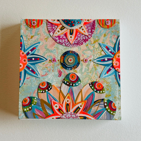 Small square wood panel art with a bold patterned floral design and hand-painted collage elements.