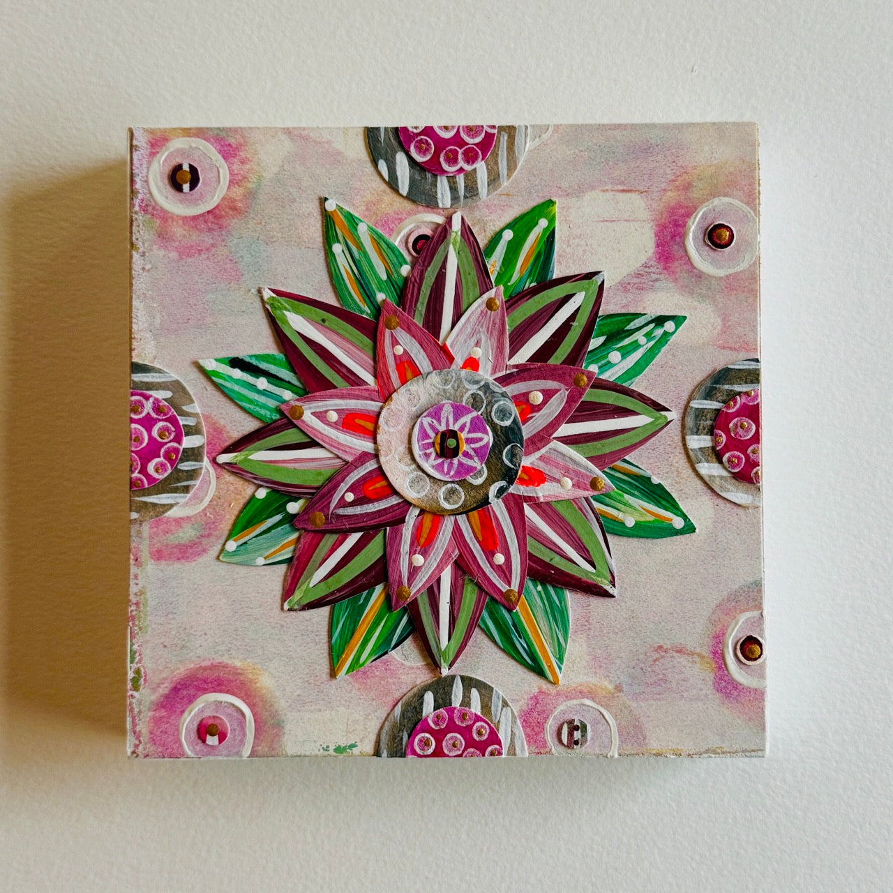 Small square wood panel art with a bold patterned floral design and hand-painted collage elements.