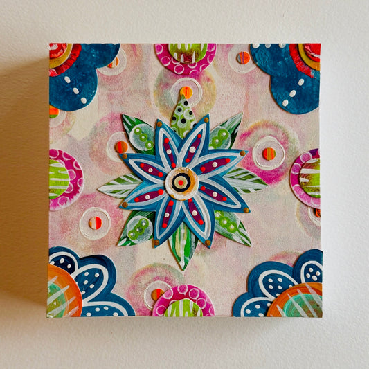 Small square wood panel art with a bold patterned floral design and hand-painted collage elements.
