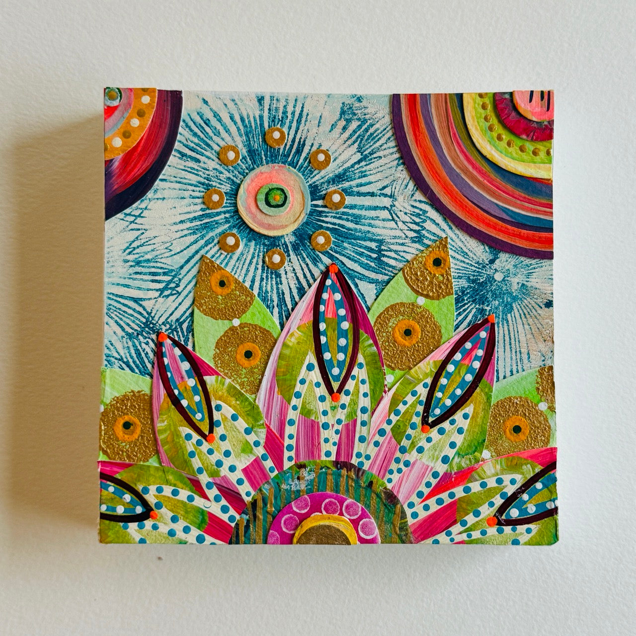 Small square wood panel art with a bold patterned floral design and hand-painted collage elements.