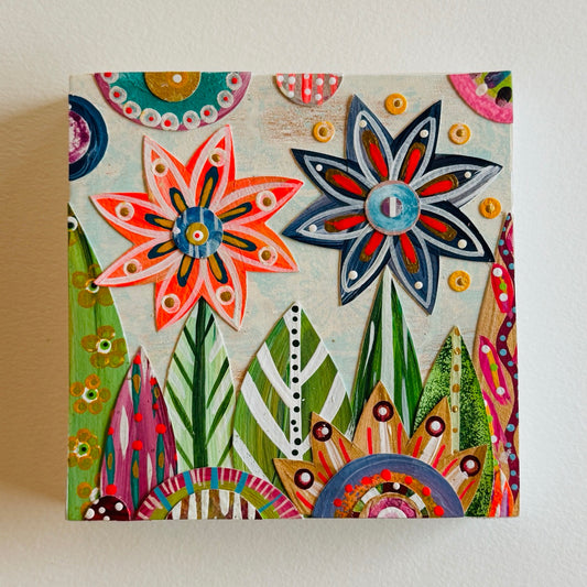 Small square wood panel art with a bold patterned floral design and hand-painted collage elements.