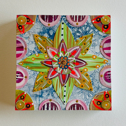 Small square wood panel art with a bold patterned floral design and hand-painted collage elements.