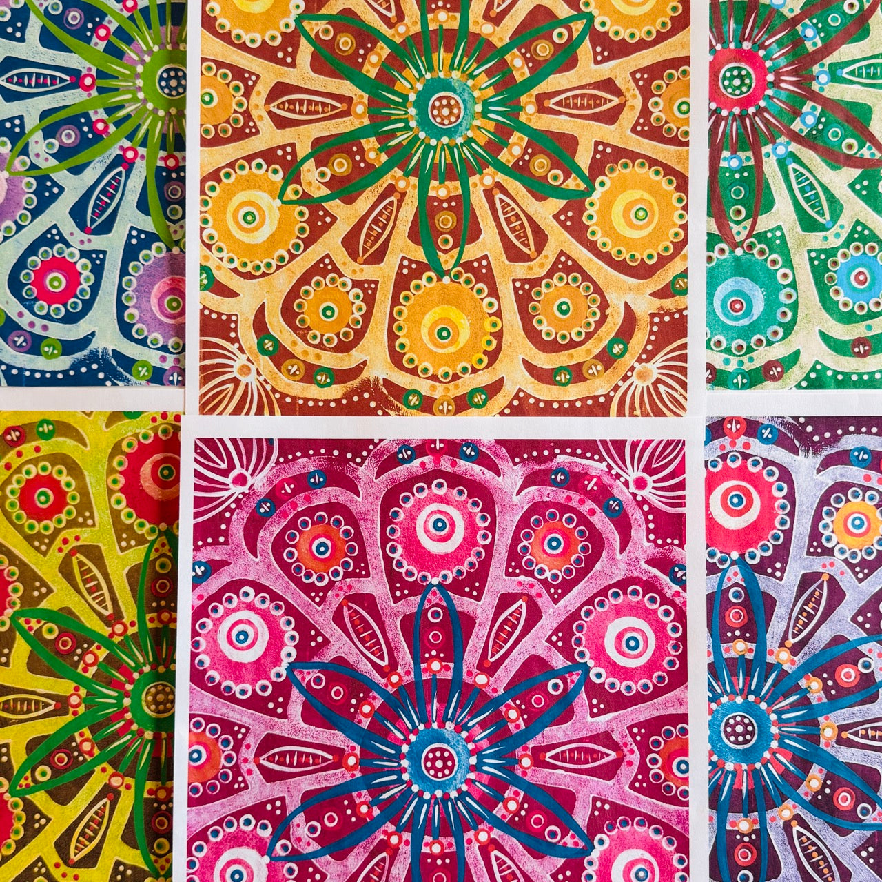 A vibrant collection of hand-painted Mexico-inspired patterned papers featuring bold floral motifs and layered geometric designs in rich pinks, purples, golds, and greens.